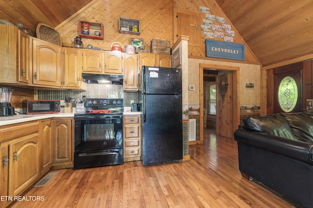 2389 Misty Ln, Sevierville, TN 37876 - kitchen with black appliances, under cabinet range hood, wood walls, wood ceiling, and light countertops