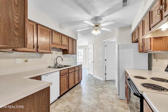 1670 Maremont Rd, Knoxville, TN 37918 - kitchen featuring white dishwasher, electric range, brown cabinetry, tasteful backsplash, and a textured ceiling