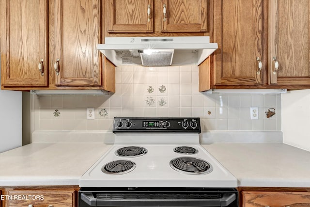 1670 Maremont Rd, Knoxville, TN 37918 - kitchen with electric stove, under cabinet range hood, and brown cabinetry