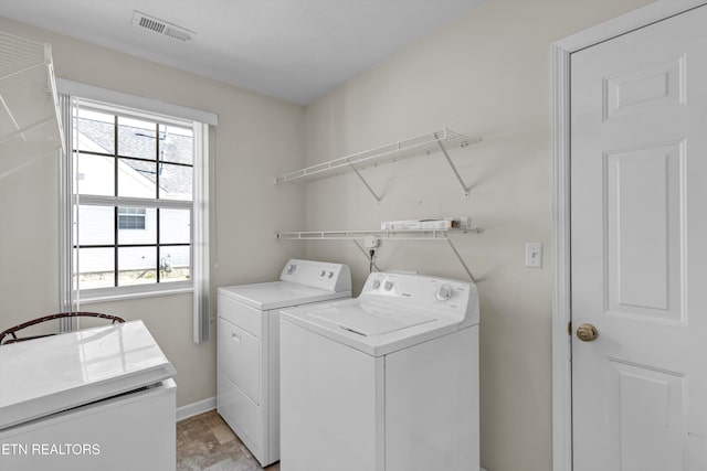 1670 Maremont Rd, Knoxville, TN 37918 - laundry room featuring separate washer and dryer and light stone finish flooring