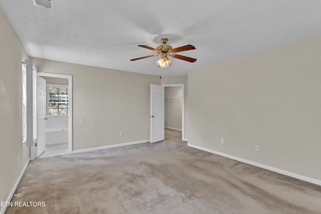 1670 Maremont Rd, Knoxville, TN 37918 - unfurnished bedroom with carpet, a walk in closet, ensuite bathroom, and ceiling fan