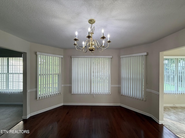 1670 Maremont Rd, Knoxville, TN 37918 - empty room with a chandelier, wood finished floors, and a textured ceiling