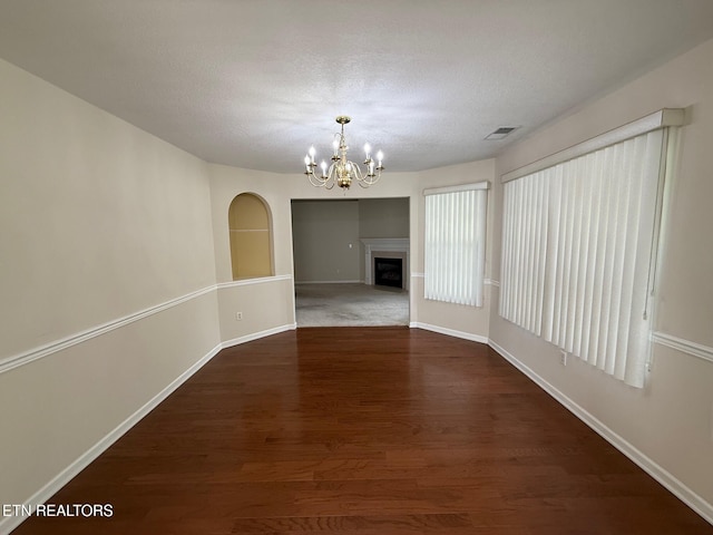 1670 Maremont Rd, Knoxville, TN 37918 - unfurnished dining area with a chandelier, dark wood-style flooring, a textured ceiling, and a fireplace
