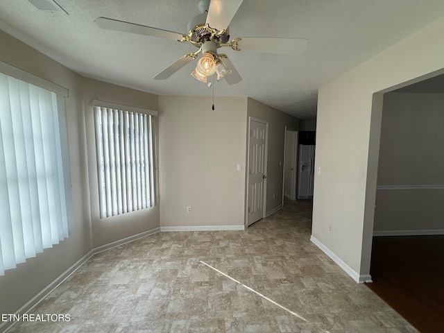 1670 Maremont Rd, Knoxville, TN 37918 - empty room featuring a ceiling fan, stone finish flooring, and a textured ceiling