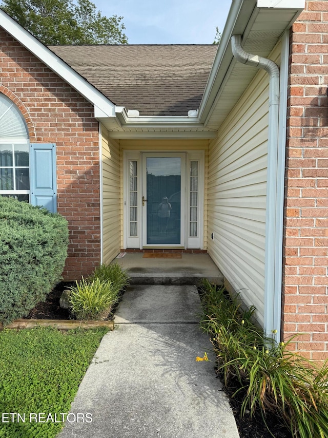 1670 Maremont Rd, Knoxville, TN 37918 - view of exterior entry featuring roof with shingles and brick siding