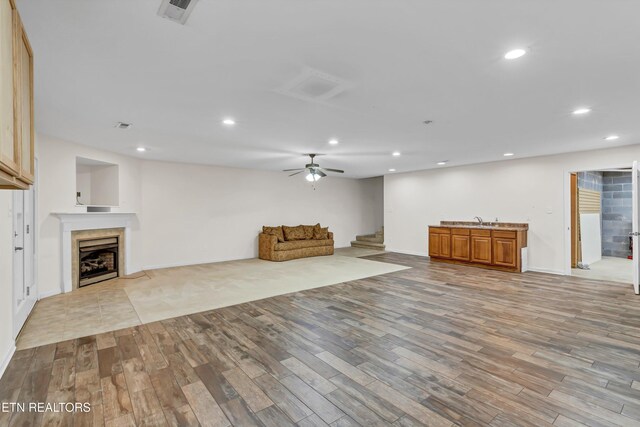 8824 Carriage House Way, Knoxville, TN 37923 - unfurnished living room featuring a fireplace, light wood-type flooring, recessed lighting, and ceiling fan