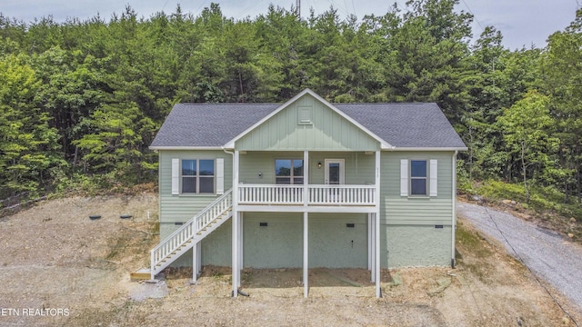 2609 Mountain Blvd, Sevierville, TN 37876 - coastal home featuring covered porch, a wooded view, stairs, and a shingled roof