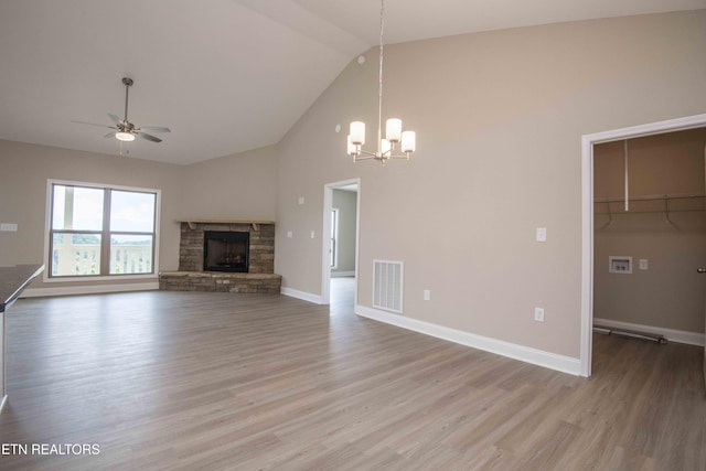 2609 Mountain Blvd, Sevierville, TN 37876 - unfurnished living room with a ceiling fan, a fireplace, high vaulted ceiling, wood finished floors, and a chandelier