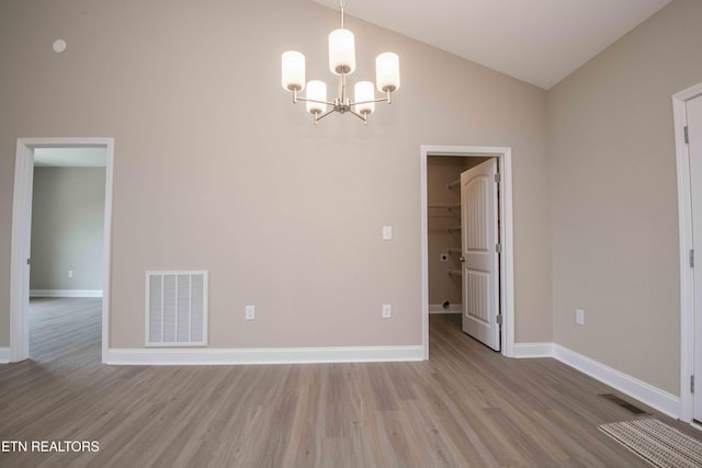 2609 Mountain Blvd, Sevierville, TN 37876 - unfurnished dining area featuring wood finished floors, a chandelier, and vaulted ceiling