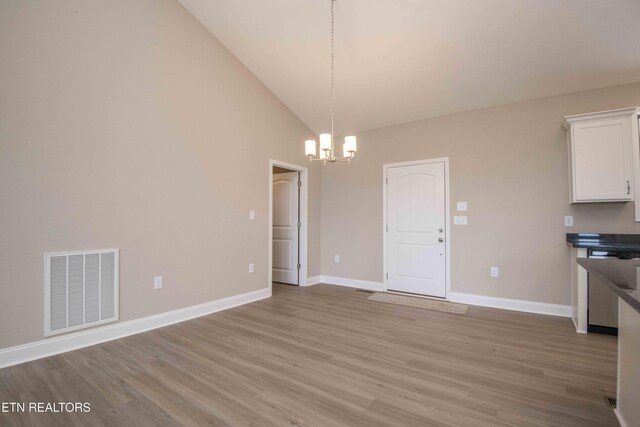2609 Mountain Blvd, Sevierville, TN 37876 - unfurnished dining area featuring a chandelier, light wood-style flooring, and high vaulted ceiling