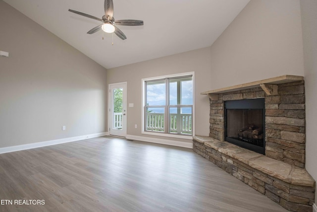 2609 Mountain Blvd, Sevierville, TN 37876 - unfurnished living room featuring wood finished floors, a fireplace, a ceiling fan, and high vaulted ceiling