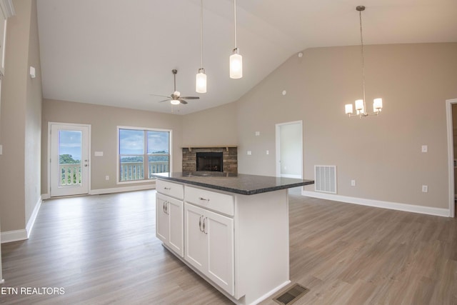 2609 Mountain Blvd, Sevierville, TN 37876 - kitchen featuring open floor plan, ceiling fan, a chandelier, light wood finished floors, and a fireplace