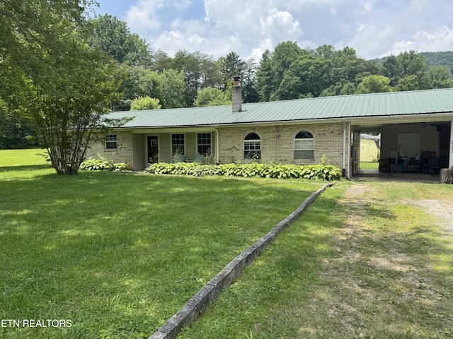225 Spring St, Spring City, TN 37381 - single story home featuring a front yard, a chimney, an attached carport, a metal roof, and brick siding