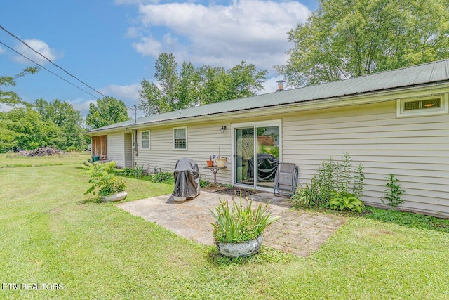 225 Spring St, Spring City, TN 37381 - rear view of house featuring a patio, a yard, and a metal roof
