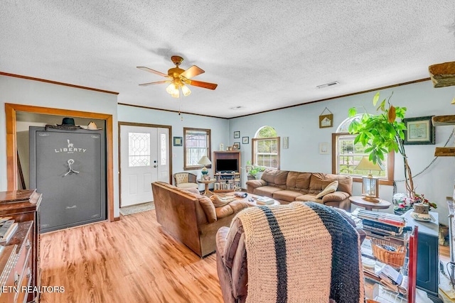 225 Spring St, Spring City, TN 37381 - living room featuring light wood finished floors, a ceiling fan, ornamental molding, and a textured ceiling