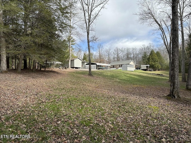 1096 Circle Dr, Jamestown, TN 38556 - view of grassy yard with an outbuilding and a pole building