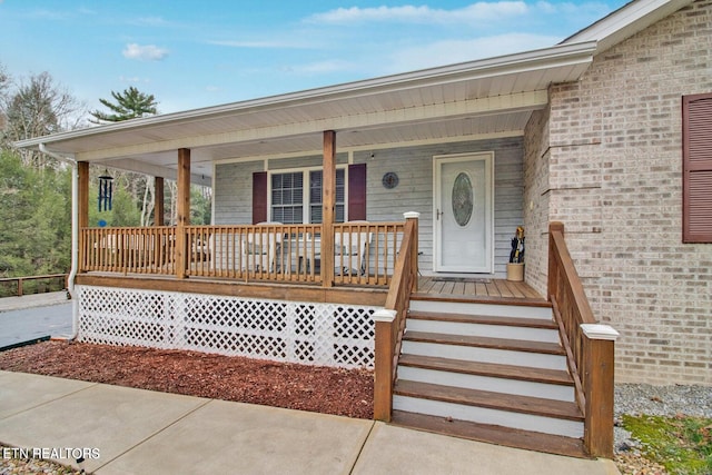 1096 Circle Dr, Jamestown, TN 38556 - view of exterior entry featuring a porch and brick siding