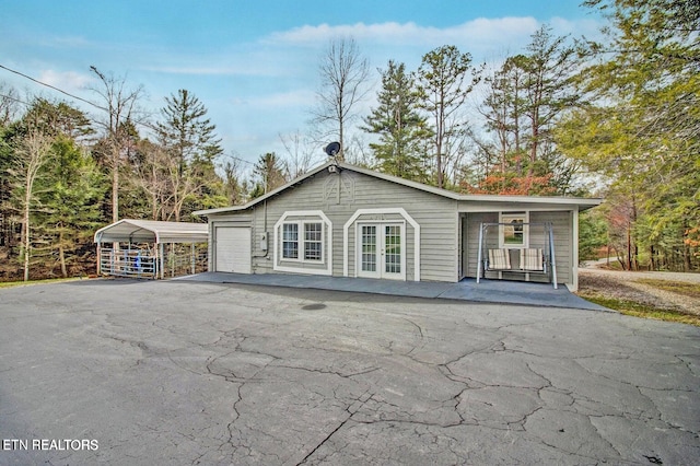 1096 Circle Dr, Jamestown, TN 38556 - back of property with driveway, a detached carport, and french doors
