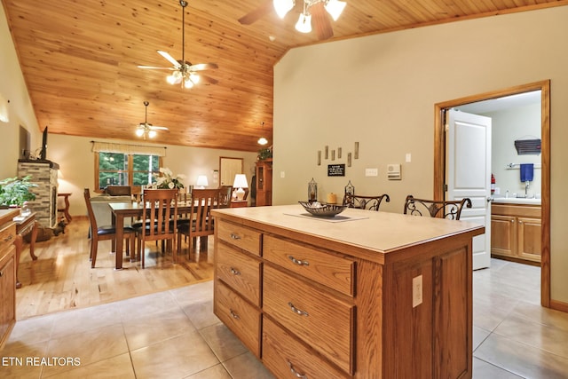 41 Crest Pl, Monterey, TN 38574 - kitchen with a ceiling fan, wooden ceiling, light tile patterned floors, a center island, and brown cabinets