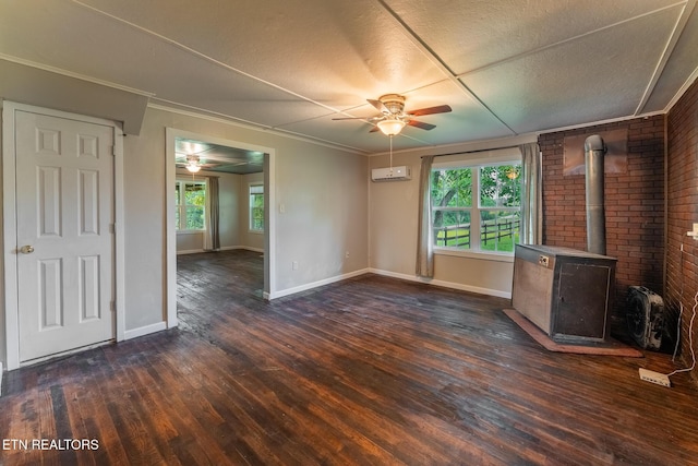 2530 Roslin Rd, Deer Lodge, TN 37726 - unfurnished living room with ceiling fan, dark wood-type flooring, a wood stove, and a wall mounted AC