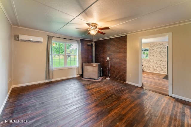 2530 Roslin Rd, Deer Lodge, TN 37726 - unfurnished living room featuring wood finished floors, plenty of natural light, ceiling fan, a wall mounted AC, and brick wall