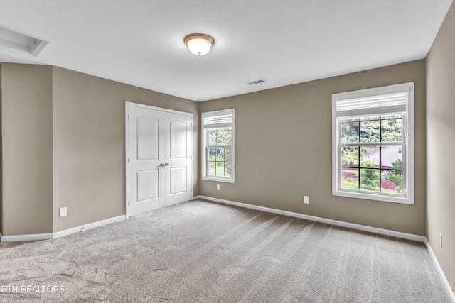 2017 Gusty Wind Ln, Knoxville, TN 37932 - unfurnished bedroom featuring multiple windows, carpet floors, and a closet