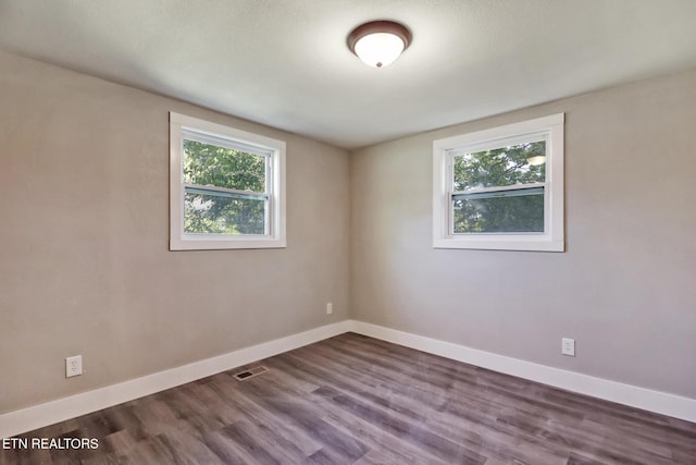 1700 E 1st St, Crossville, TN 38555 - empty room featuring healthy amount of natural light and dark wood-type flooring