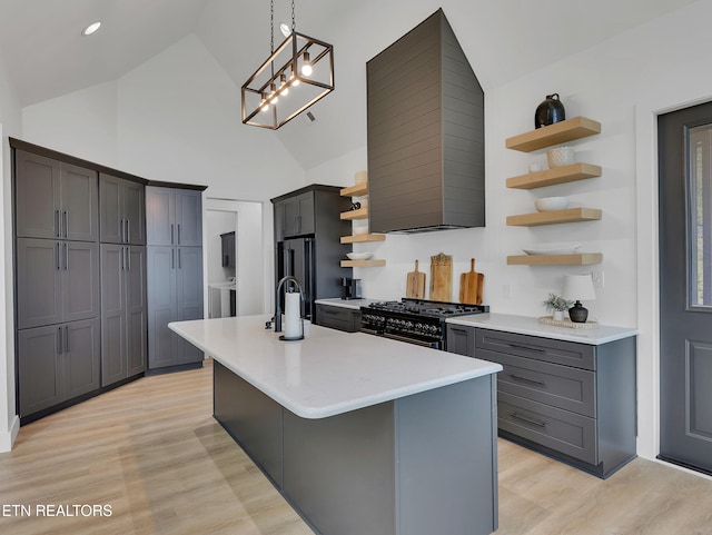 1848 Mountain Ash Way, Sevierville, TN 37876 - kitchen with open shelves, gas range, light countertops, a center island with sink, and light wood-style floors