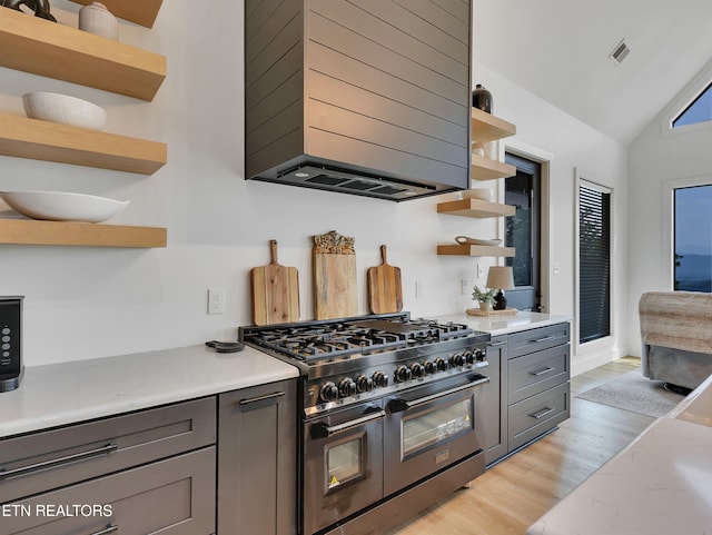 1848 Mountain Ash Way, Sevierville, TN 37876 - kitchen with open shelves, range with two ovens, wall chimney exhaust hood, light wood finished floors, and gray cabinets