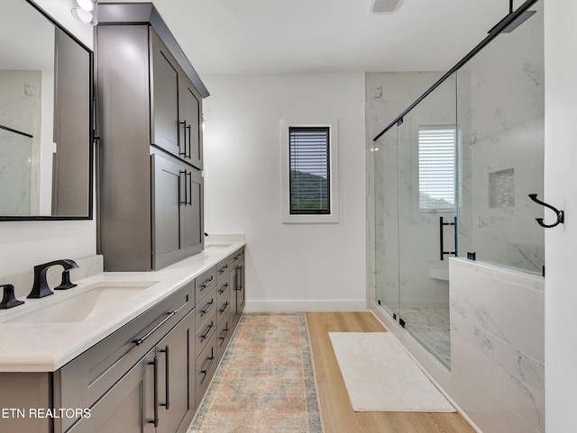 1848 Mountain Ash Way, Sevierville, TN 37876 - bathroom featuring a marble finish shower, double vanity, and wood finished floors
