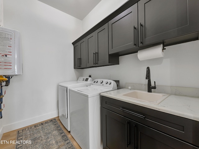 1848 Mountain Ash Way, Sevierville, TN 37876 - laundry room with cabinet space, washer and clothes dryer, light wood finished floors, and tankless water heater