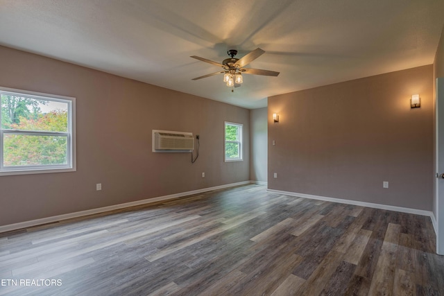 150 Ray Cross Rd, Harriman, TN 37748 - spare room featuring a ceiling fan, wood finished floors, and an AC wall unit