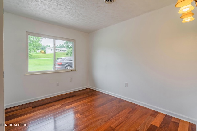 150 Ray Cross Rd, Harriman, TN 37748 - spare room featuring wood finished floors and a textured ceiling