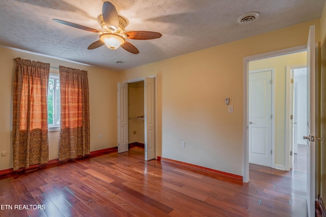 150 Ray Cross Rd, Harriman, TN 37748 - unfurnished bedroom featuring a textured ceiling, wood finished floors, and a ceiling fan