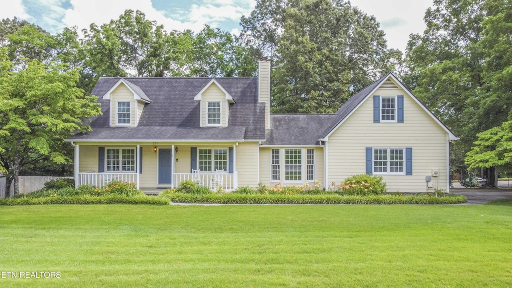 228 Wells Fargo Dr Unit 2, Knoxville, TN 37934 - cape cod house with a porch, a front lawn, a chimney, and roof with shingles