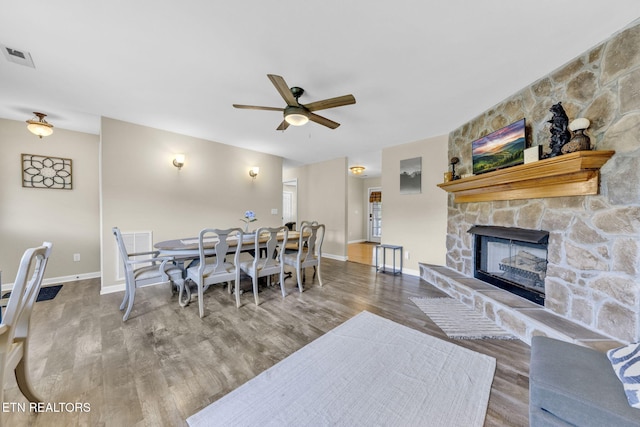3183 Wears Dr, Sevierville, TN 37862 - dining room with a ceiling fan, wood finished floors, and a stone fireplace