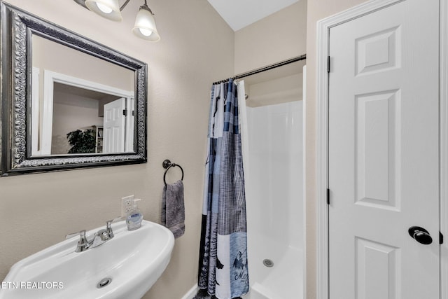 3183 Wears Dr, Sevierville, TN 37862 - bathroom featuring a shower with curtain and a sink