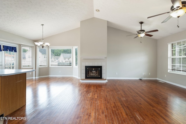 541 Pebble Creek Rd, Knoxville, TN 37918 - unfurnished living room featuring a ceiling fan, hardwood / wood-style flooring, a tile fireplace, a chandelier, and a textured ceiling