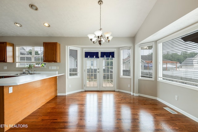 541 Pebble Creek Rd, Knoxville, TN 37918 - kitchen featuring a chandelier, brown cabinets, wood finished floors, hanging light fixtures, and vaulted ceiling