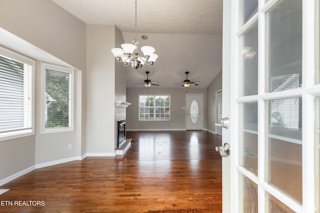 541 Pebble Creek Rd, Knoxville, TN 37918 - unfurnished living room with vaulted ceiling, dark wood finished floors, a chandelier, ceiling fan, and a tile fireplace