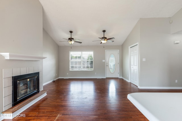 541 Pebble Creek Rd, Knoxville, TN 37918 - unfurnished living room with vaulted ceiling, dark wood-type flooring, ceiling fan, and a tiled fireplace