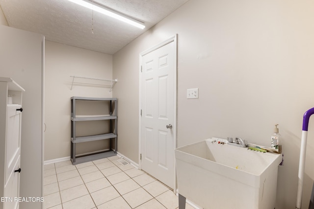 541 Pebble Creek Rd, Knoxville, TN 37918 - laundry area with light tile patterned floors and a textured ceiling