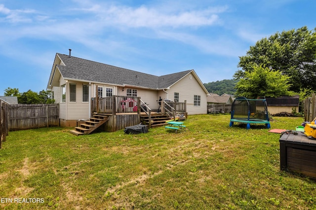 541 Pebble Creek Rd, Knoxville, TN 37918 - rear view of house featuring a trampoline, a wooden deck, and a fenced backyard