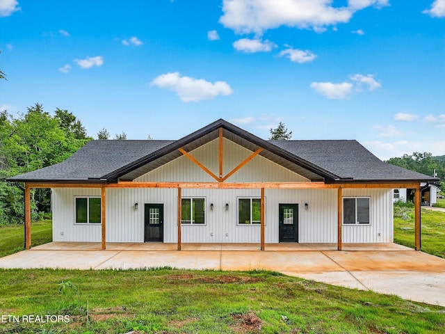 1570 W Dumplin Valley Rd, Dandridge, TN 37725 - back of house with a shingled roof, a yard, and a patio