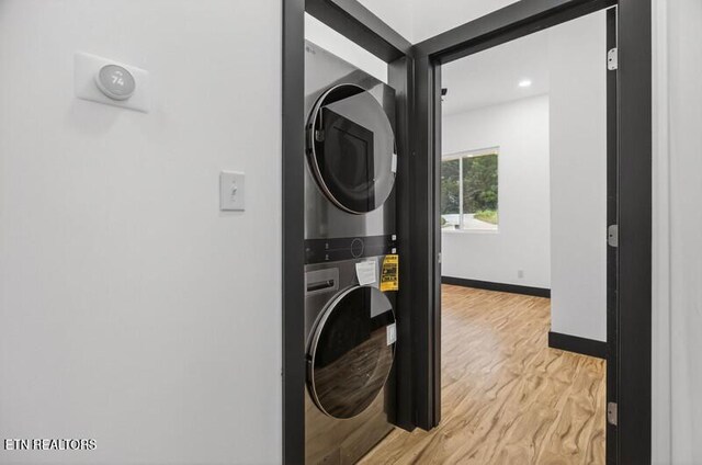 1570 W Dumplin Valley Rd, Dandridge, TN 37725 - washroom with stacked washer and clothes dryer, light wood-style flooring, and recessed lighting