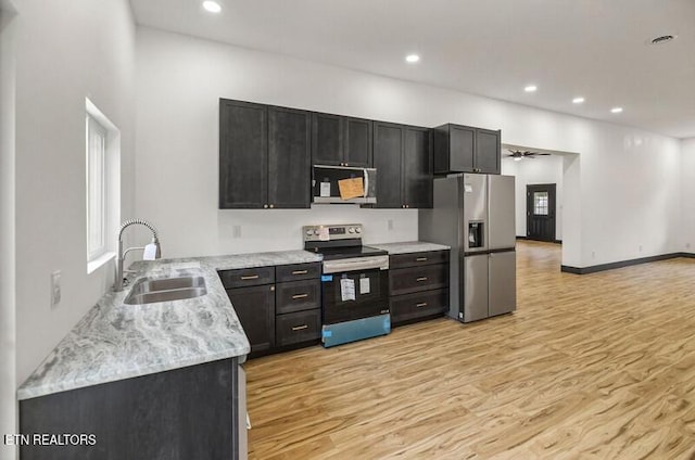1570 W Dumplin Valley Rd, Dandridge, TN 37725 - kitchen with stainless steel appliances, light wood-style flooring, dark cabinets, recessed lighting, and ceiling fan