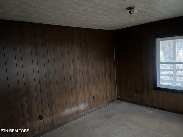 332 Ridge Rd, Lancing, TN 37770 - spare room with wood walls and a textured ceiling