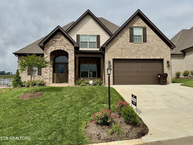 2107 Lantern Park Ln, Knoxville, TN 37932 - view of front of property with a garage, concrete driveway, a front lawn, brick siding, and a shingled roof
