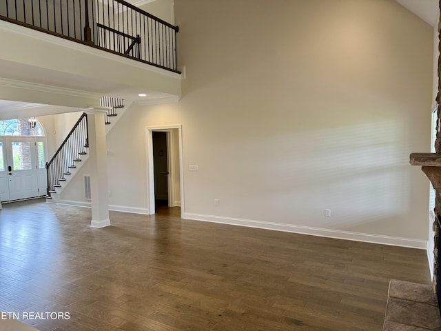 2107 Lantern Park Ln, Knoxville, TN 37932 - unfurnished living room featuring stairway, dark wood finished floors, a high ceiling, and ornamental molding