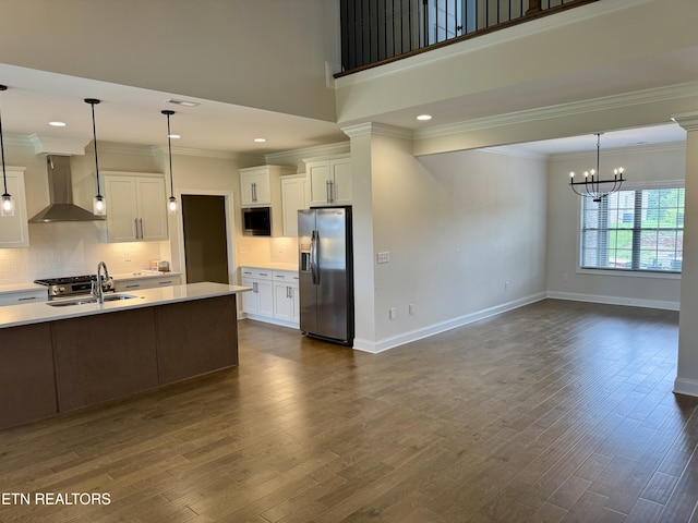 2107 Lantern Park Ln, Knoxville, TN 37932 - kitchen featuring wall chimney exhaust hood, stainless steel appliances, crown molding, light countertops, and a chandelier
